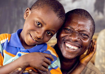 Smiling man and child